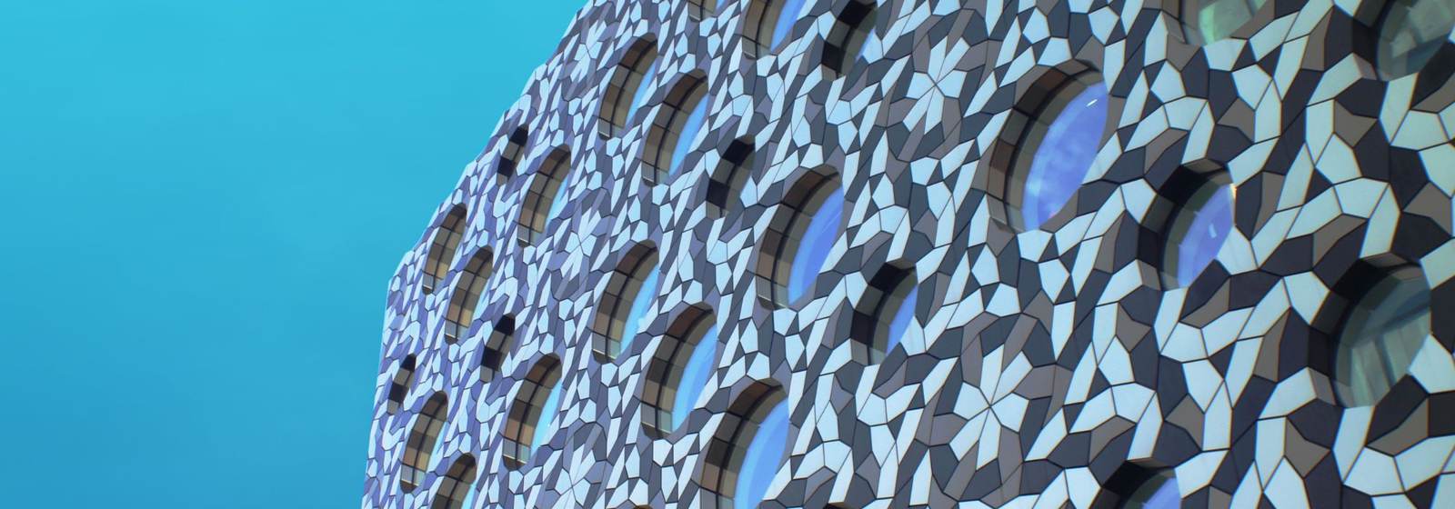 The angular, tessellated facade of a modern building, representing the structured systems behind a well-built health business